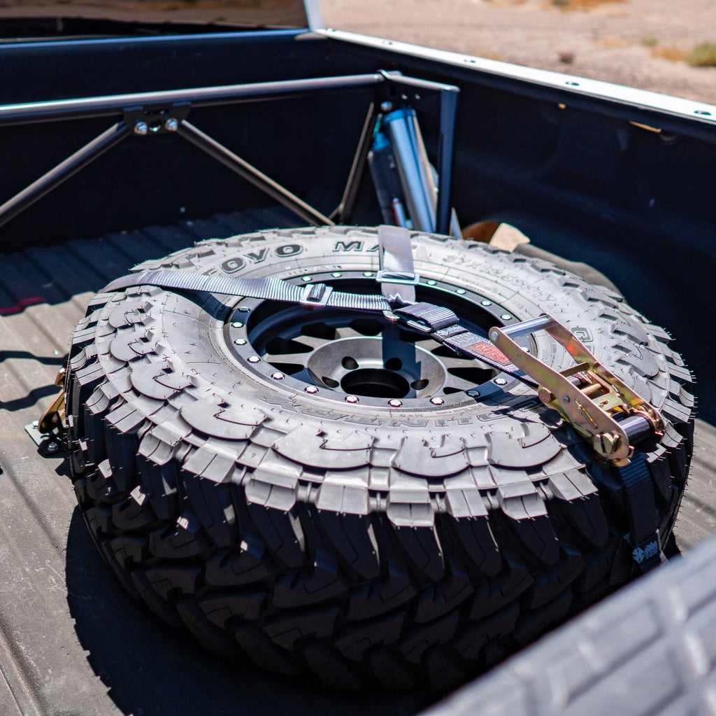 sdhq built spare tire brackets installed in bed of truck with spare tire display
